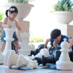 Kids are playing oversized chess