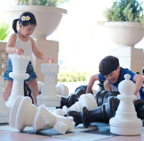 Kids are playing oversized chess