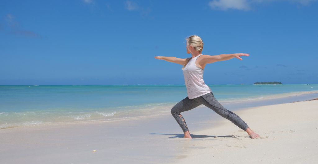 A woman is practicing Tai Chi at the Micro beach